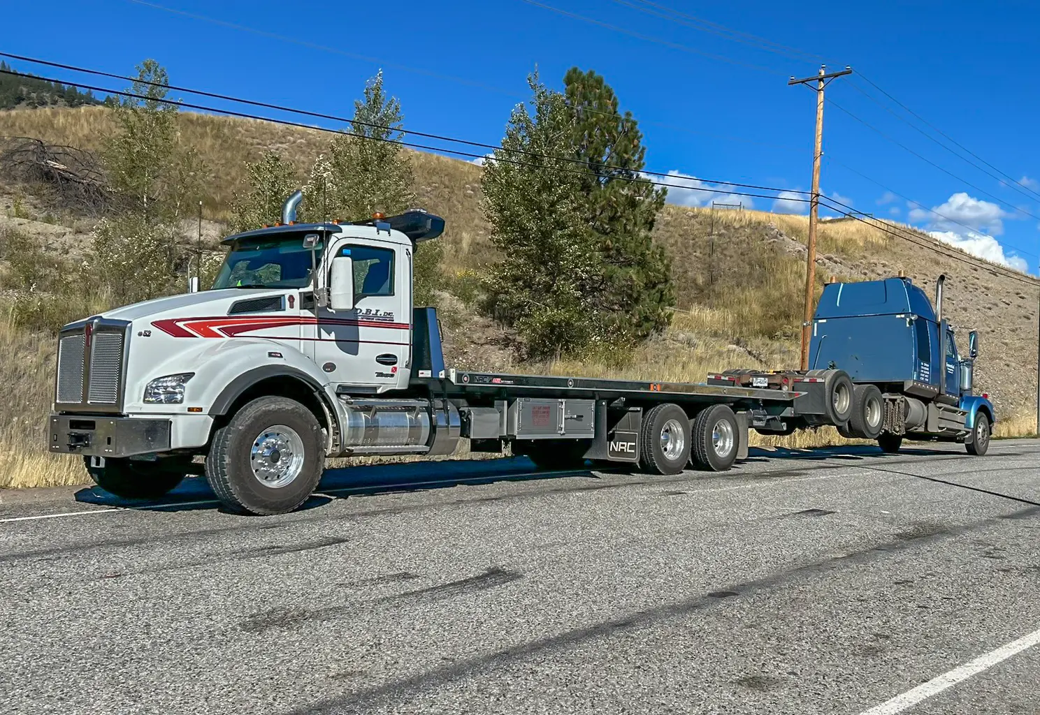 a transport truck towing a truck